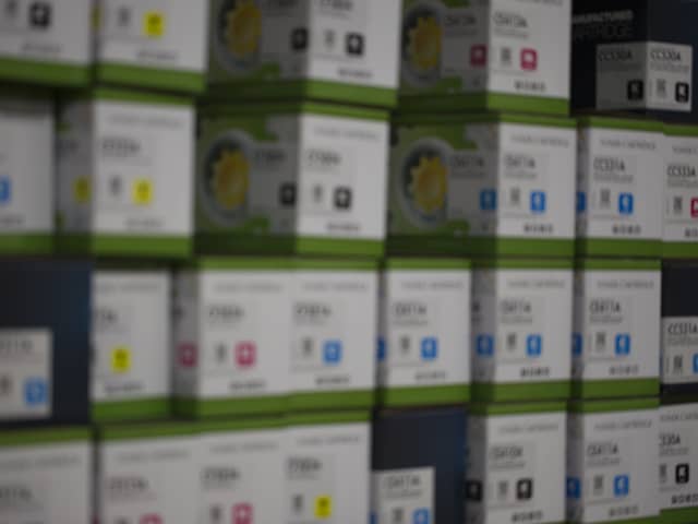 A wall of printer cartridge boxes