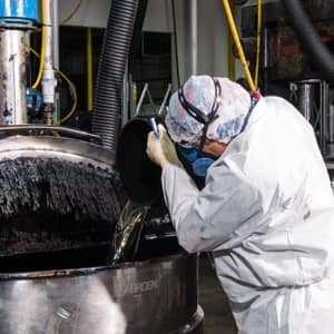 A Static Control employee working on the printer ink formulation in a factory