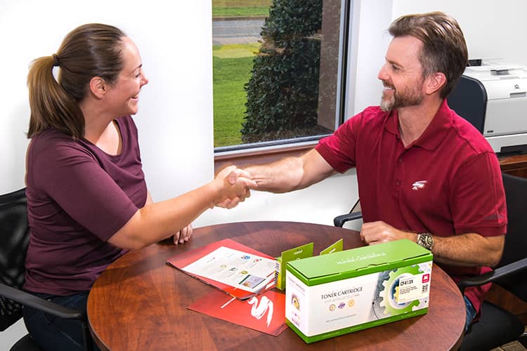 A Static Control employee shaking hands with a customer