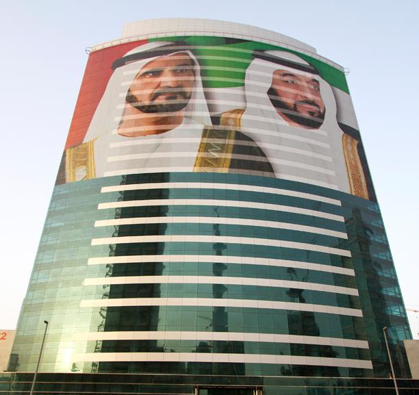 A picture of two men on a tall building in Dubai