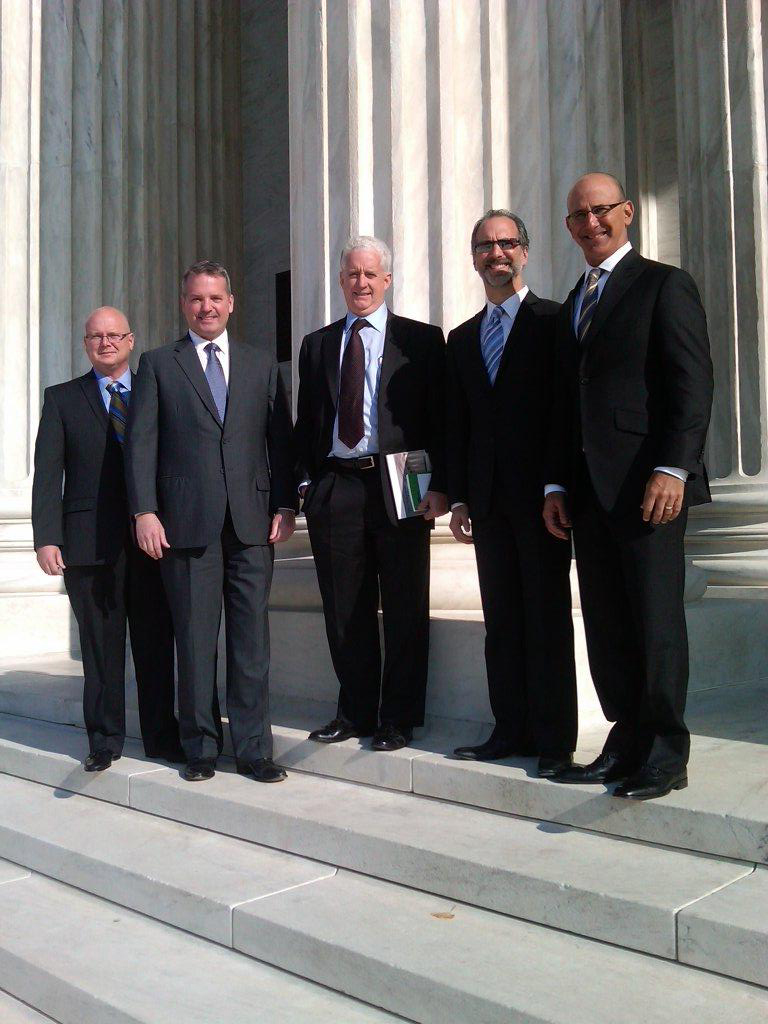 Static Control executives standing in front of a government building